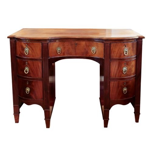 437 - A late 19th century mahogany inverted bowfronted desk in the Georgian style - the moulded top over a... 