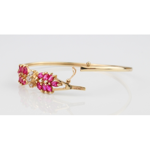 237 - A 10ct yellow gold bangle - stamped '10K MEX', the foliate setting with pink and clear stones, proba... 