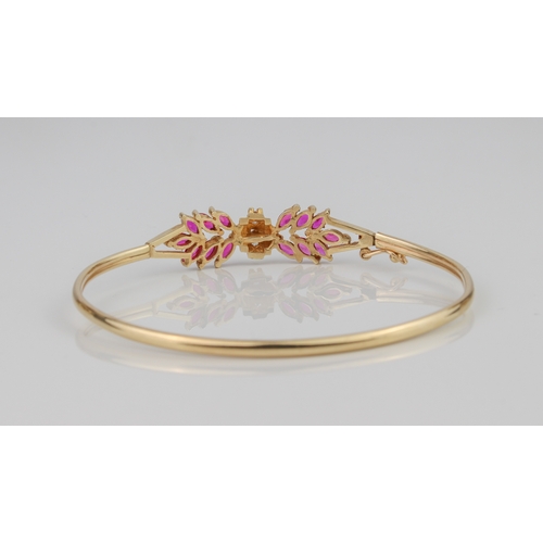 237 - A 10ct yellow gold bangle - stamped '10K MEX', the foliate setting with pink and clear stones, proba... 