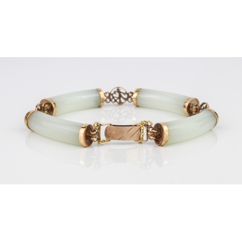 216 - A Chinese 9ct gold and celadon jade bracelet - with four curved, cylindrical jade bars joined by pie... 