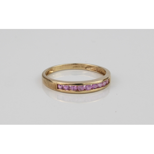 199 - A 9ct gold and pink sapphire channel-set ring - with nine round cut sapphires, hallmarked QVC Birmin... 