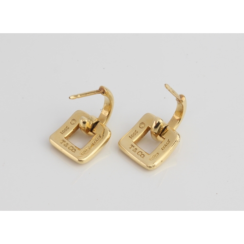 180 - A pair of 18ct yellow gold earrings signed 'Tiffany'  - of buckle shape, suspended from half-hoops, ... 