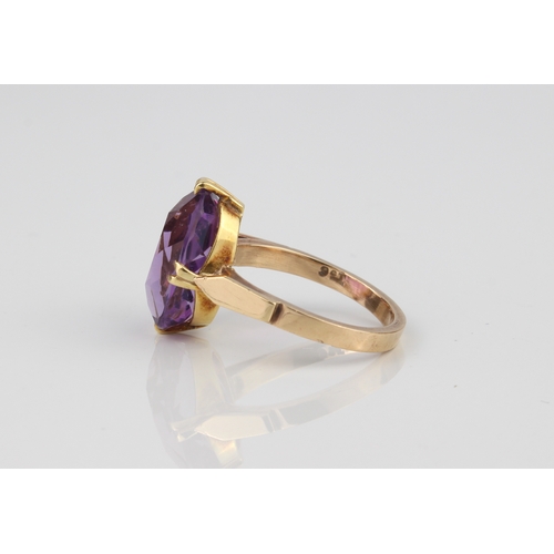 207 - A 9ct gold ring and amethyst ring - stamped '9CT', the large 14.5 x 11mm oval cut amethyst over swor... 