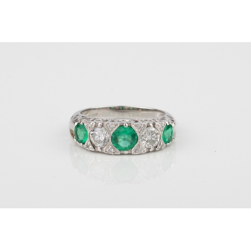 227 - A fine quality 18ct white gold, emerald and diamond ring - Birmingham hallmarks, with three graduate... 