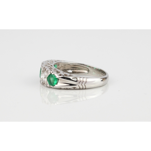 227 - A fine quality 18ct white gold, emerald and diamond ring - Birmingham hallmarks, with three graduate... 