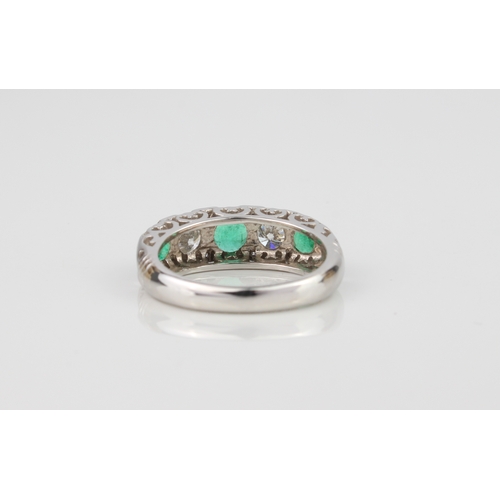 227 - A fine quality 18ct white gold, emerald and diamond ring - Birmingham hallmarks, with three graduate... 