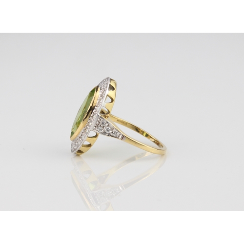 239 - An 18ct yellow and white gold, peridot and diamond ring - hallmarked London 2010, the marquis cut pe... 