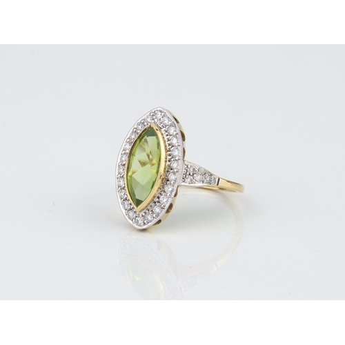 239 - An 18ct yellow and white gold, peridot and diamond ring - hallmarked London 2010, the marquis cut pe... 