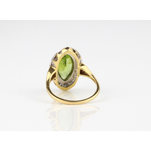 239 - An 18ct yellow and white gold, peridot and diamond ring - hallmarked London 2010, the marquis cut pe... 