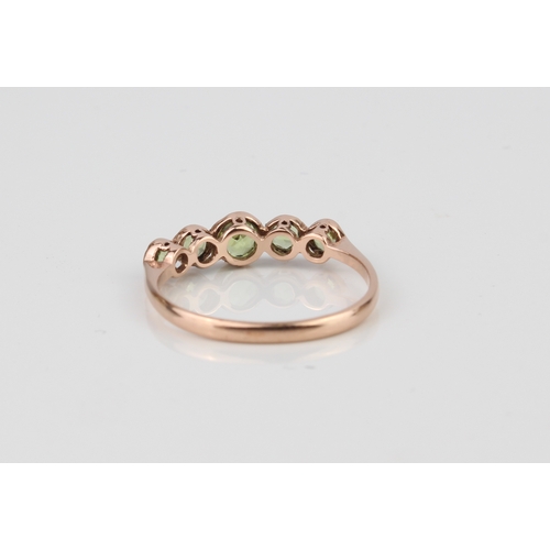 218 - An antique 9ct rose gold and peridot five-stone ring - hallmarked London 1909, the five graduated ro... 