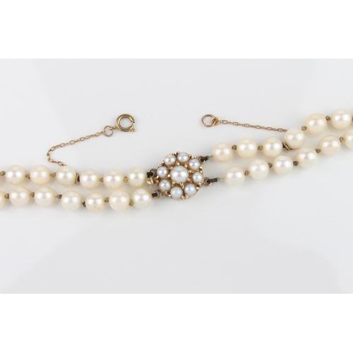 233 - A double row cultured pearl necklace with 9ct gold and pearl clasp - London hallmarks, 43.5 cm long.