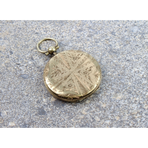 232 - A late Victorian rolled gold locket - circular, chased with flowers and foliage in a radial pattern,... 