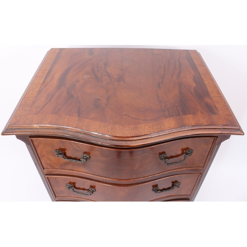 409 - A repoduction Georgian style mahogany serpentine chest of small proportions - the cross banded, moul... 