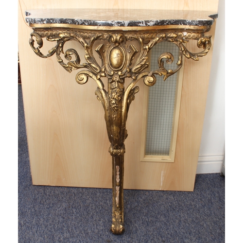 436 - An antique carved giltwood and marble console table - the later grey and white marble top on a folia... 