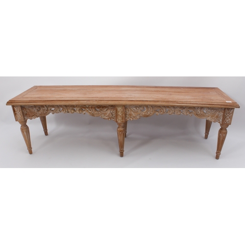 513 - An Oriental carved, limed hardwood long stool or bench - modern, the cleated, moulded seat over a fo... 