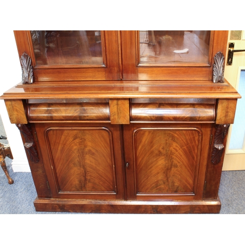 463 - A Victorian mahogany glazed cupboard bookcase - the moulded cavetto cornice on foliate carved bracke... 