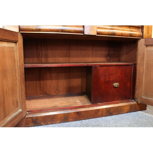 463 - A Victorian mahogany glazed cupboard bookcase - the moulded cavetto cornice on foliate carved bracke... 