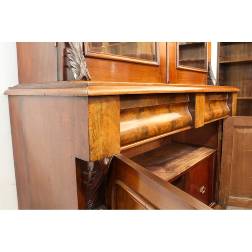 463 - A Victorian mahogany glazed cupboard bookcase - the moulded cavetto cornice on foliate carved bracke... 