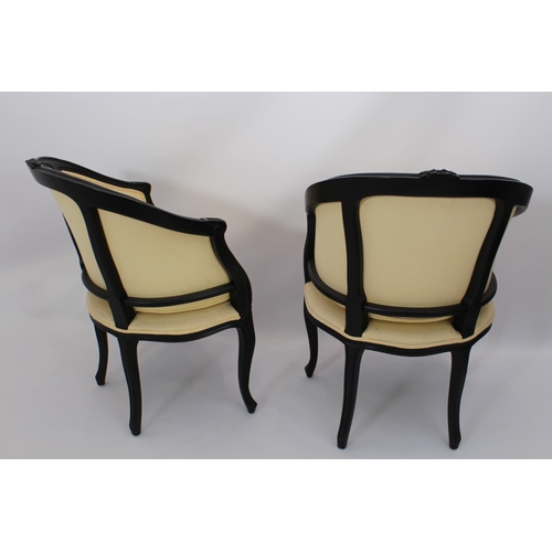 514 - A pair of ebonised bergeres in the Louis XVI style - modern, with pale gold upholstery, 61.5 cm wide... 