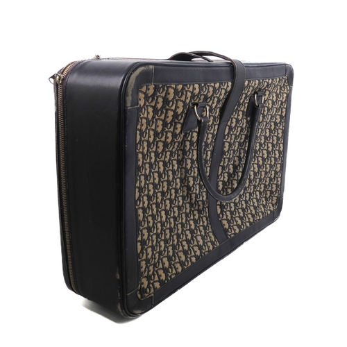 578 - A vintage Christian Dior leather and monogram fabric suitcase - 1980s, in dark blue leather with mon... 