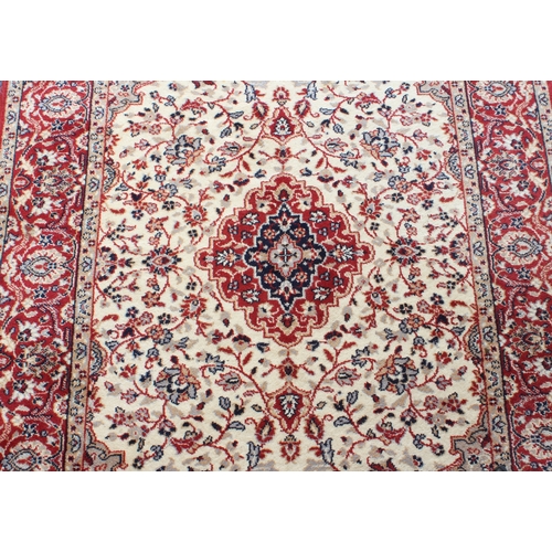 561 - A Kashan style machine made wool rug - 178 x 121 cm.