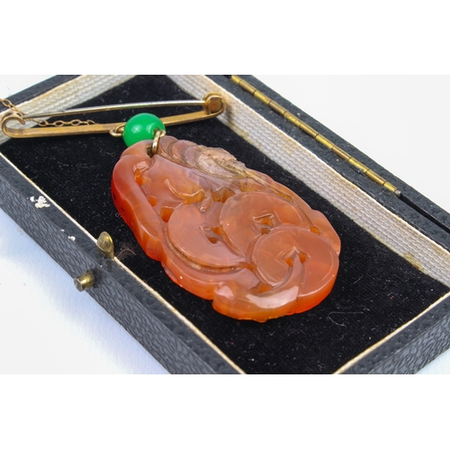 230 - A mid-century Chinese carved jade plaque on bar brooch - the ovoid, russet jade plaque pierced and c... 