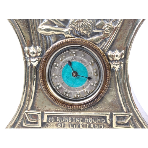 262 - An Arts and Crafts mantle clock; the face silver plated with embossed design of Old Father Time and ... 