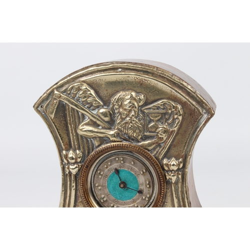 262 - An Arts and Crafts mantle clock; the face silver plated with embossed design of Old Father Time and ... 