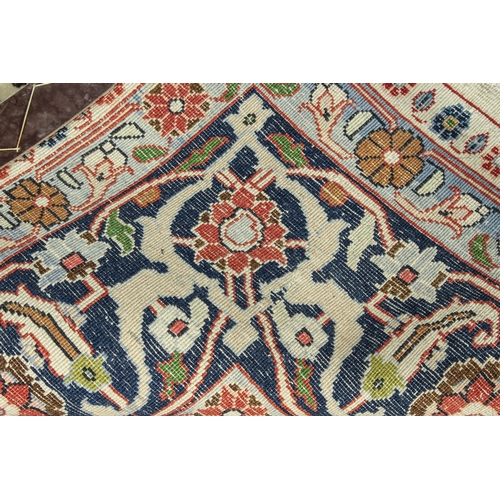 567 - A large north-west Persian Varamin wool rug - the ivory field with all over polychrome floral decora... 