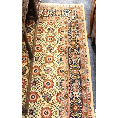 567 - A large north-west Persian Varamin wool rug - the ivory field with all over polychrome floral decora... 