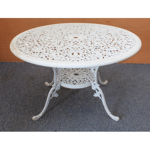 539 - A white-painted cast metal circular garden table and four chairs - the table with pierced leafy scro... 