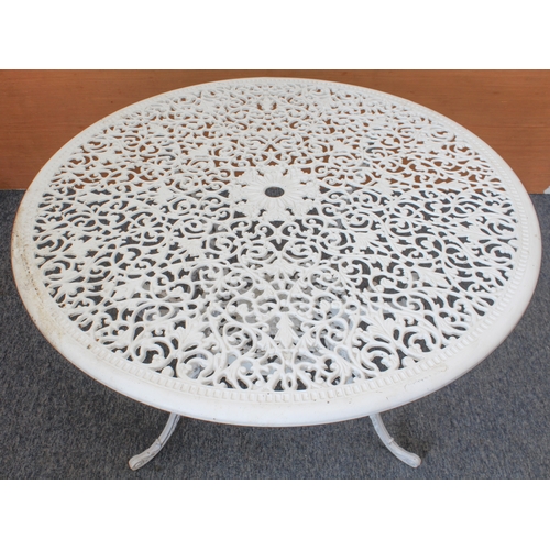 539 - A white-painted cast metal circular garden table and four chairs - the table with pierced leafy scro... 