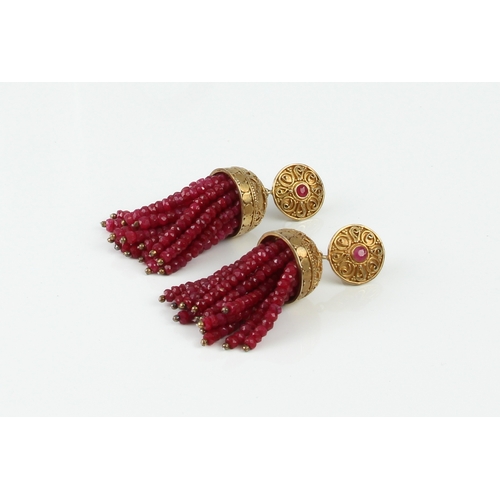 182 - A pair of silver gilt and ruby drop earrings - probably Indian, the tassel form drop with strings of... 