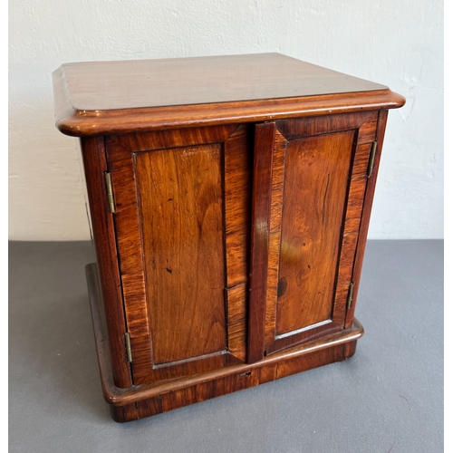 721 - A late 19th / early 20th century rosewood table cabinet - the moulded top over two cross banded, pan... 