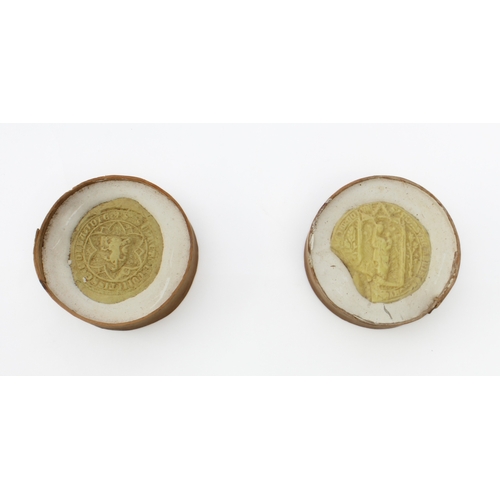 753 - Four 19th century replica abbey and college seals - each in moulded pale yellow opaque glass and hou... 