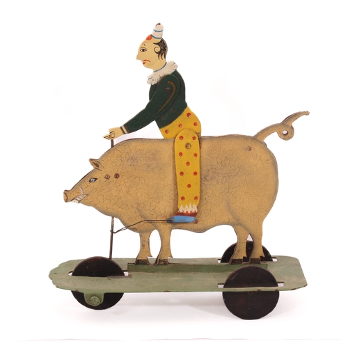 773 - A 19th century style painted metal pig automata toy - the large pig ridden by a clown, who rocks bac... 