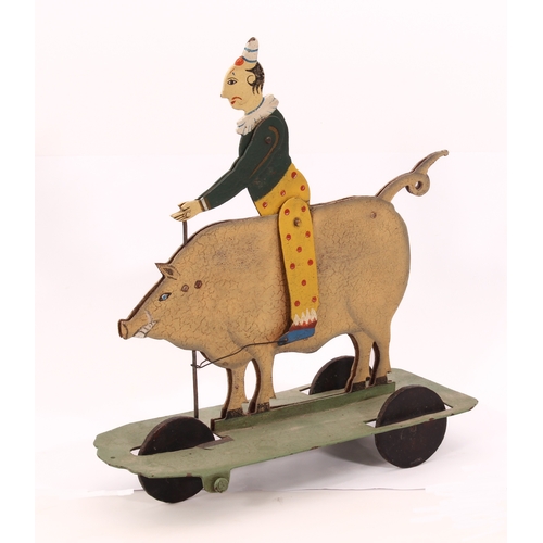 773 - A 19th century style painted metal pig automata toy - the large pig ridden by a clown, who rocks bac... 