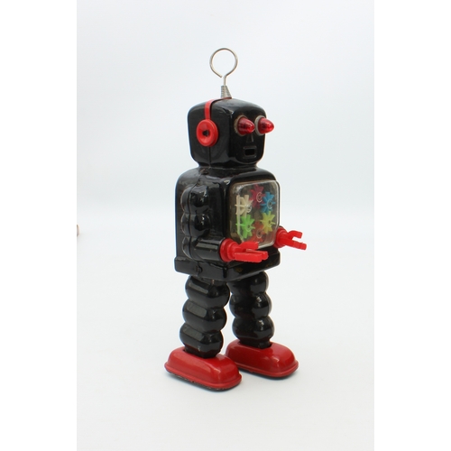 777 - A Japanese tinplate wind-up clockwork High Wheel Robot by Yoshiya = 1960s, finished in black and red... 