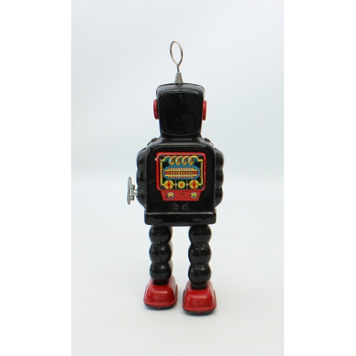 777 - A Japanese tinplate wind-up clockwork High Wheel Robot by Yoshiya = 1960s, finished in black and red... 