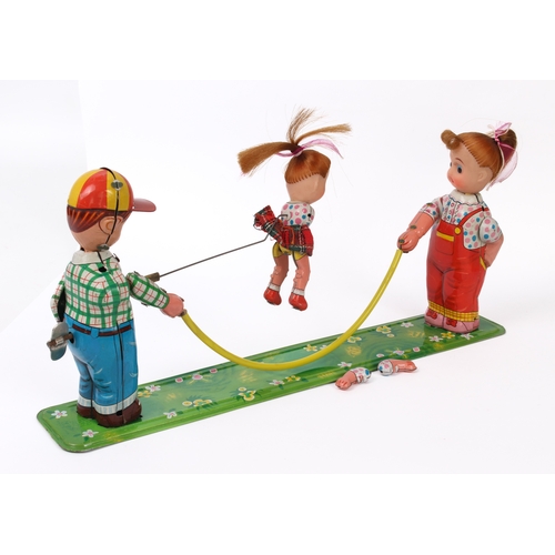 778 - A Japanese tinplate and vinyl wind-up clockwork toy, 'Girl Skipping Rope' - by Toplay (TPS) of Japan... 