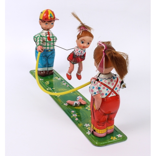 778 - A Japanese tinplate and vinyl wind-up clockwork toy, 'Girl Skipping Rope' - by Toplay (TPS) of Japan... 