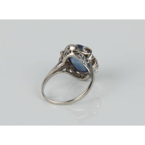 195 - A mid-century 14ct white gold, cabochon cornflower blue sapphire and diamond cluster ring - stamped ... 