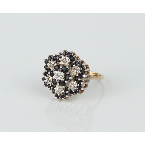 235 - A 9ct yellow gold, sapphire and diamond cluster ring - hallmarked Birmingham 1986, the blue round cu... 