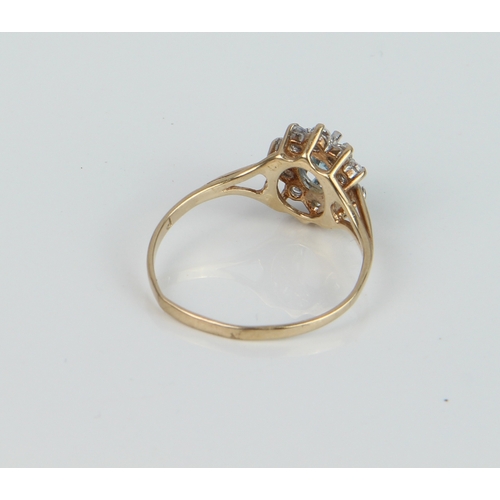 236 - A 9ct yellow gold, topaz and white stone cluster ring - the oval cut 5.5 x 3.75mm topaz within a bor... 