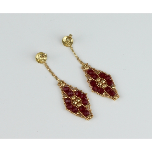 241 - A pair of 18ct yellow gold and garnet drop earrings - the lozenge shaped drops with ten facet cut ga... 