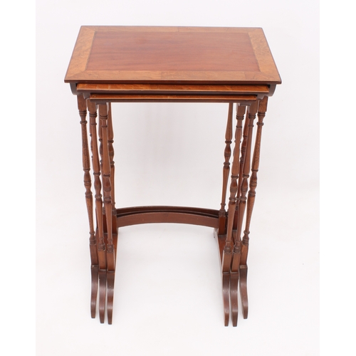 429 - An Edwardian nest of three mahogany and birds eye maple tables - rectangular, the mahogany tops broa... 