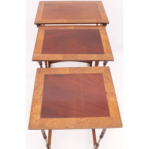 429 - An Edwardian nest of three mahogany and birds eye maple tables - rectangular, the mahogany tops broa... 