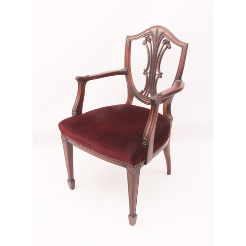 443 - A mahogany elbow chair in the Hepplewhite style - 1920s, the shield back with pierced vase splat hea... 