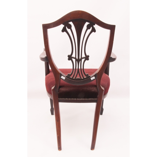 443 - A mahogany elbow chair in the Hepplewhite style - 1920s, the shield back with pierced vase splat hea... 