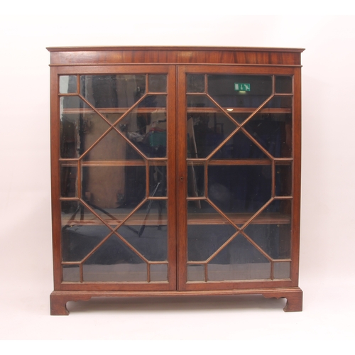 450 - A Georgian-style mahogany glazed bookcase - 1920s, the moulded top over a pair of 13-pane astragal g... 